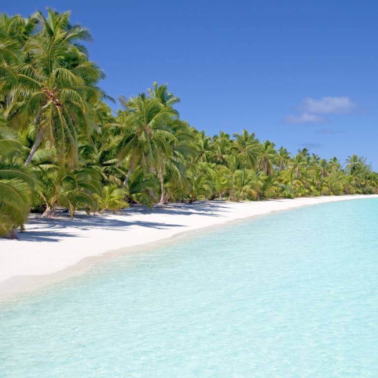 Sunny beach with blue water
